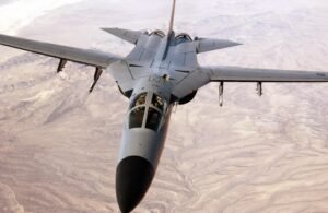 RAAF General Dynamics F-111C flying over Australian terrain with wings partially swept